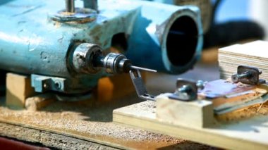 Drilling a plywood at wood factory close-up