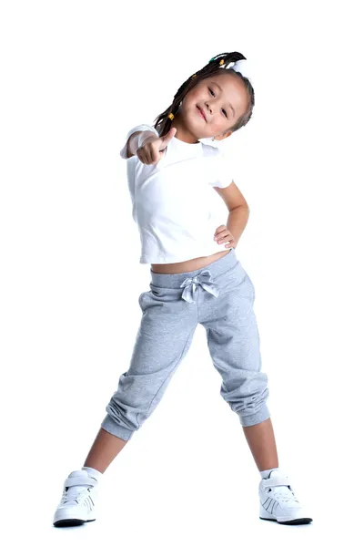 Happy little girl in sportswear thumbs up isolated — Zdjęcie stockowe