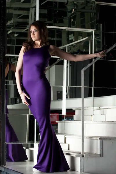 Pretty brunette woman in long purple dress — Stock Photo, Image