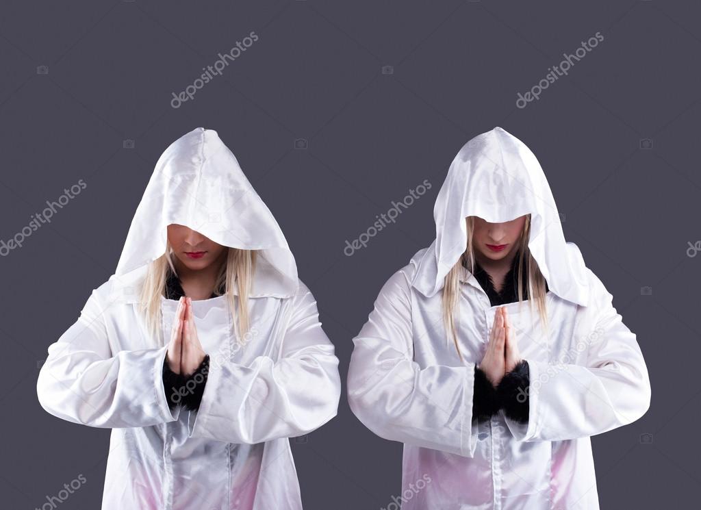 Two transvestites in white cloaks