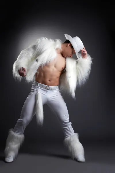 Athletic striptease dancer in white cowboy costume — Stock Photo, Image