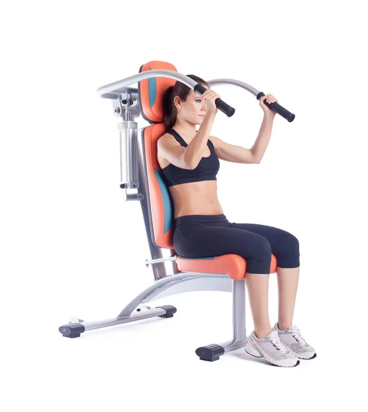Brunette woman sitting on exerciser isolated — Stock Photo, Image