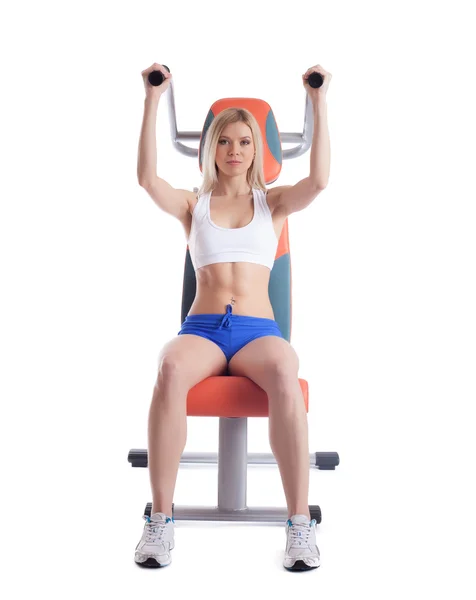 Beautiful blonde on power exerciser — Stock Photo, Image