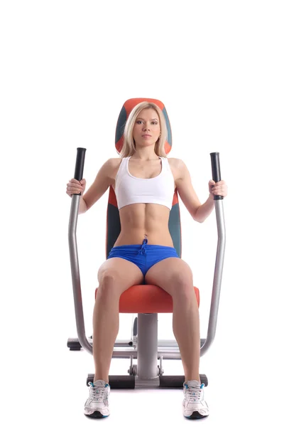 Athletic blonde on modern gym equipment — Stock Photo, Image