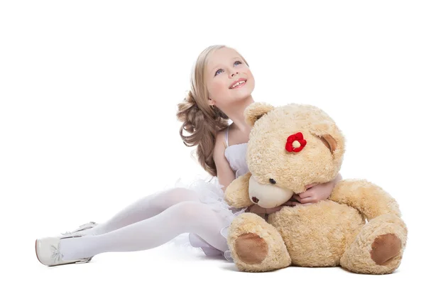 Beautiful little girl hugging big teddy bear — Stock Photo, Image