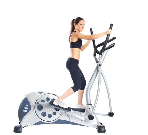 Pretty brunette doing exercises on gym equipment — Stock Photo, Image