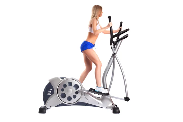 Slim blonde woman on exerciser — Stock Photo, Image