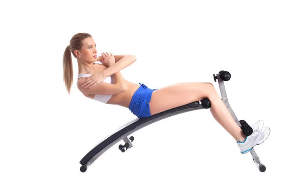 Sporty young woman on exerciser — Stock Photo, Image