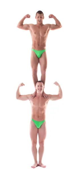 Two smiling force acrobat posing in studio — Stock Photo, Image