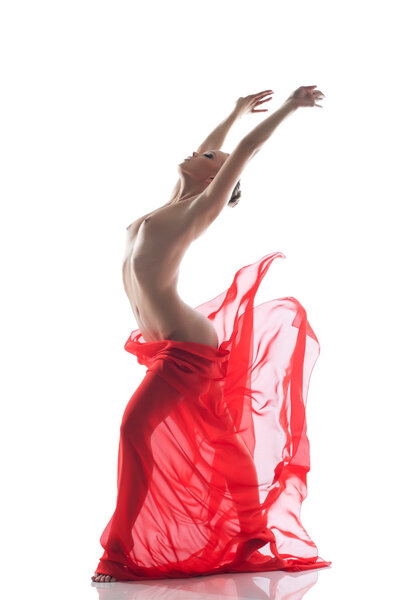 Young topless woman dancing with cloth in studio, isolated on white