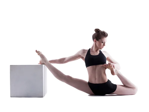 Beautiful girl doing stretching in studio — Stock Photo, Image