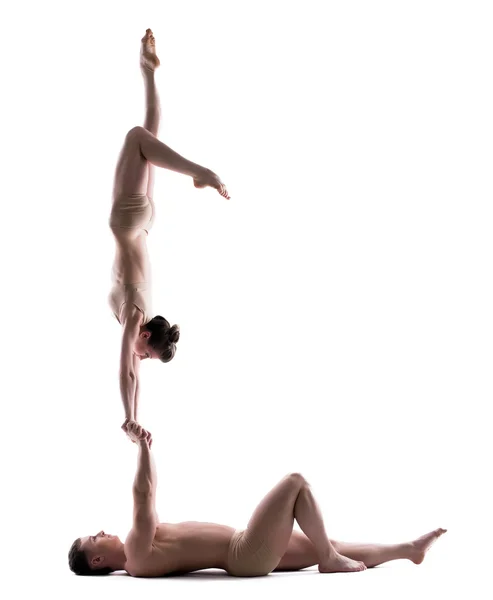 Pair of young acrobats training in studio — Stock Photo, Image