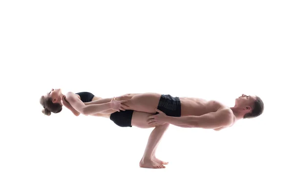 Couple of flexible gymnasts balancing in studio — Stock Photo, Image