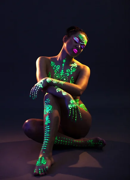 Graceful model posing with UV pattern on body — Stock Photo, Image