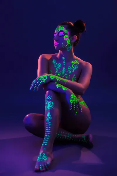 Attractive girl posing with colorful UV makeup — Stock Photo, Image