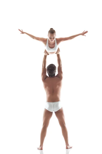 Image of two young gymnasts - man holds slim girl — Stock Photo, Image