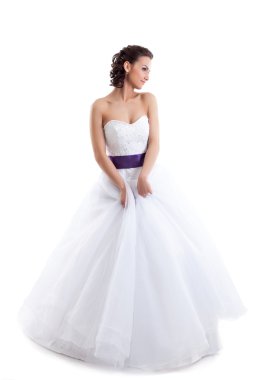 Cute girl posing in wedding gown isolated on white