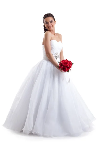 Красива жінка позує у весільній сукні з букетом — стокове фото