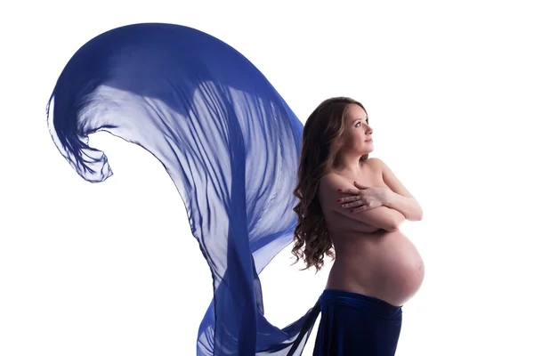 Imagen de la mujer embarazada posando con tela azul —  Fotos de Stock