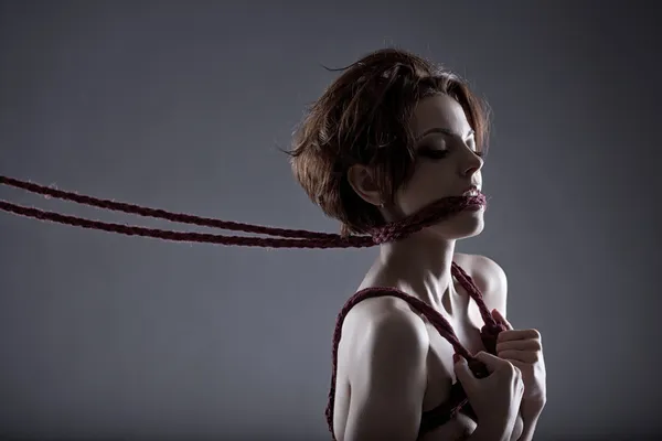 Passionate red-haired model tied with rope — Stock Photo, Image