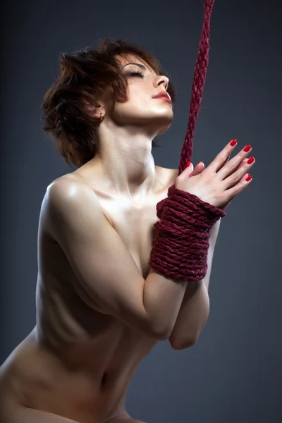 Sexual red-haired naked woman tied with rope Royalty Free Stock Photos