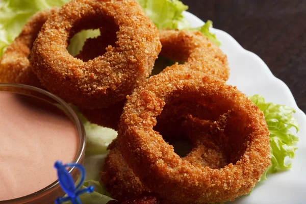 Image of meat breaded rings served with sauce — Stock Photo, Image