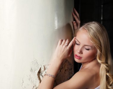 sevimli sarışın yaslanarak sütun, yakın çekim poz