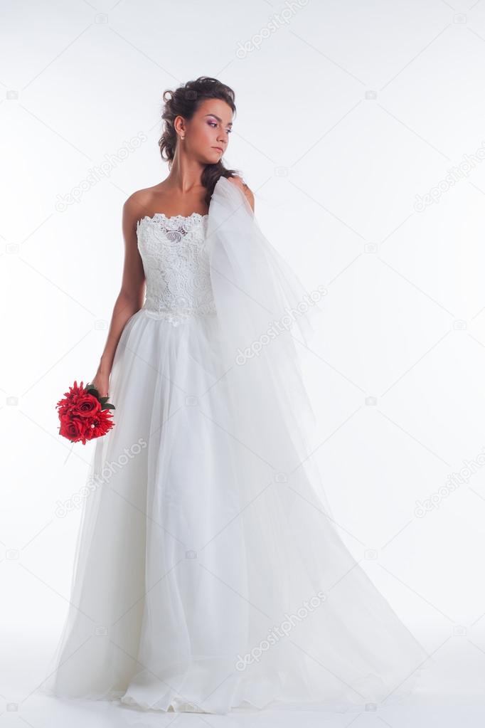 Image of pretty young bride posing with veil
