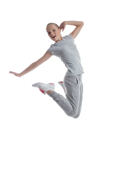 Menina desportiva pulando em estúdio isolado no branco — Fotografia de Stock