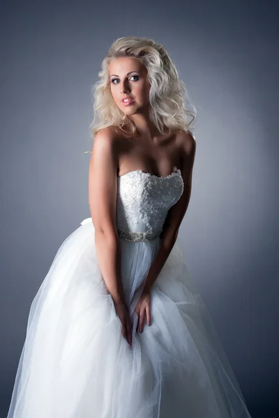 Romantic blonde posing in lush wedding dress — Stock Photo, Image