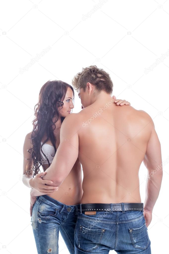 Embrace of semi-nude couples posing in jeans