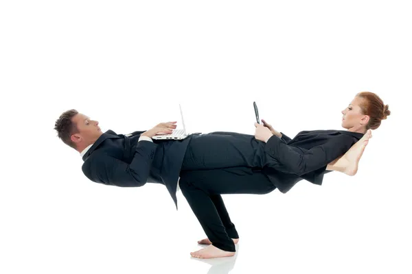 Busy partners posing in unreal pose with laptops — Stock Photo, Image