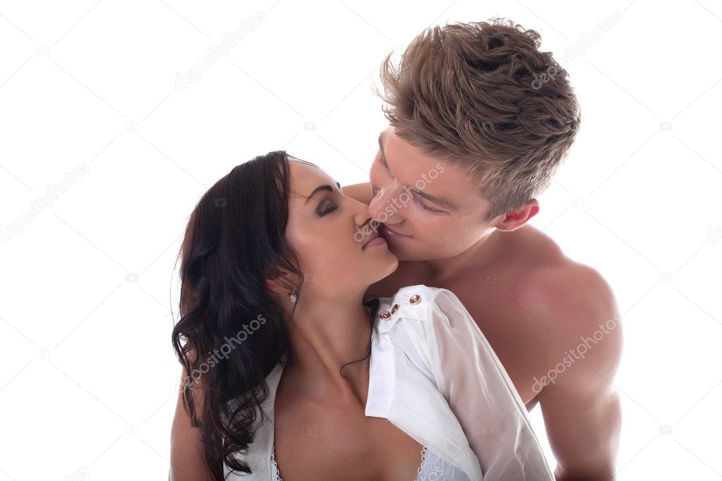 Young romantic couple kissing, isolated on white