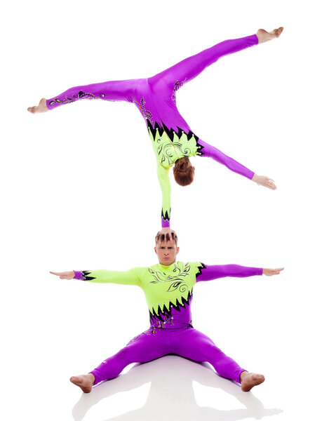Focused acrobats balancing, isolated on white