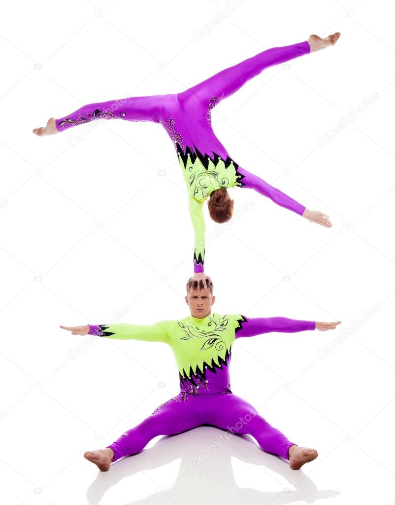 Focused acrobats balancing, isolated on white