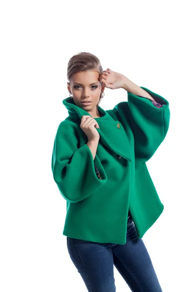 Pretty young model posing in green coat, close-up — Stock Photo, Image