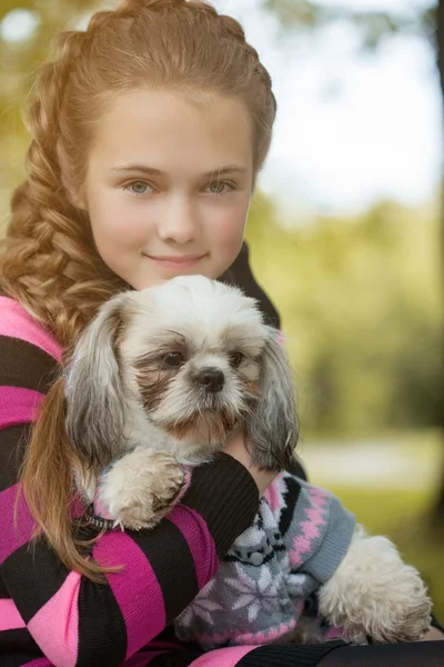 Portrait of beautiful little girl hugging her dog — Stock Photo, Image