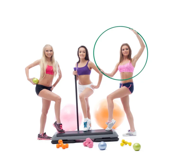 Cute female athletes posing with sports equipment — Stock Photo, Image