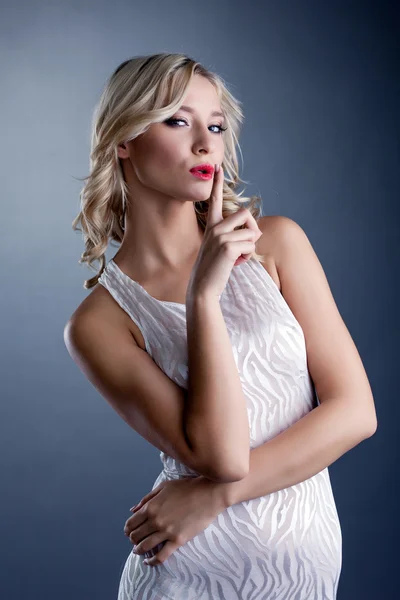 Studio shot of stylish young blonde in white dress — Stock Photo, Image