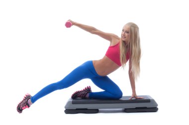 Smiling muscular girl exercising with dumbbells clipart