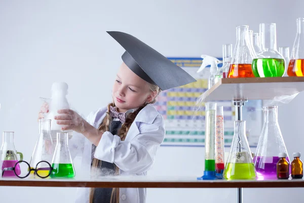 Educated girl following experimental results — Stock Photo, Image