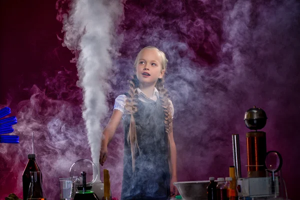 Charmed little girl pocing in cloud of steam — Stock Photo, Image