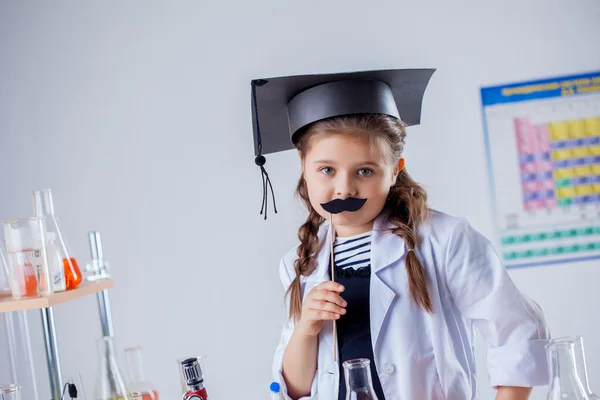 Adorable little girl posing with fake mustache — Stock Photo, Image