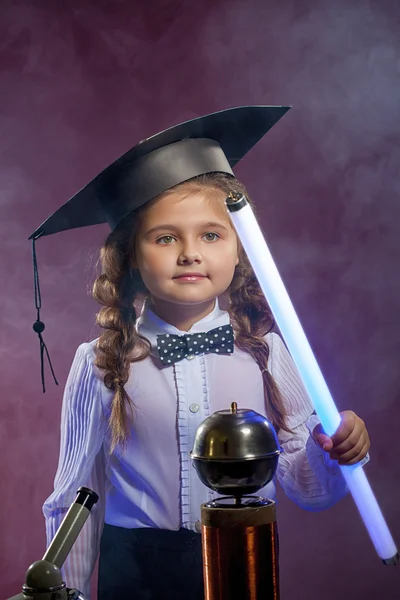 Charming little girl posing with lamp in lab — Stock Photo, Image