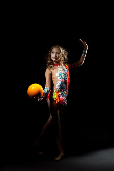 Pretty artistic gymnast dancing with ball — Stock Photo, Image