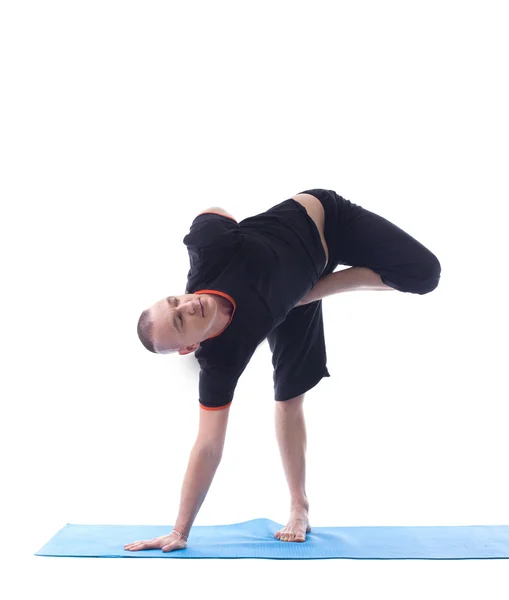 Studio shot of muscular man doing yoga — Stock Photo, Image