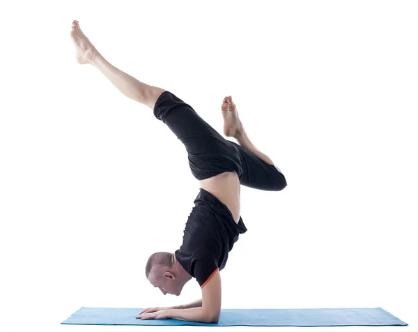 Flexible man posing in difficult yoga pose — Stock Photo, Image