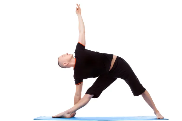 Energetic middle-aged man doing yoga poses — Stock Photo, Image