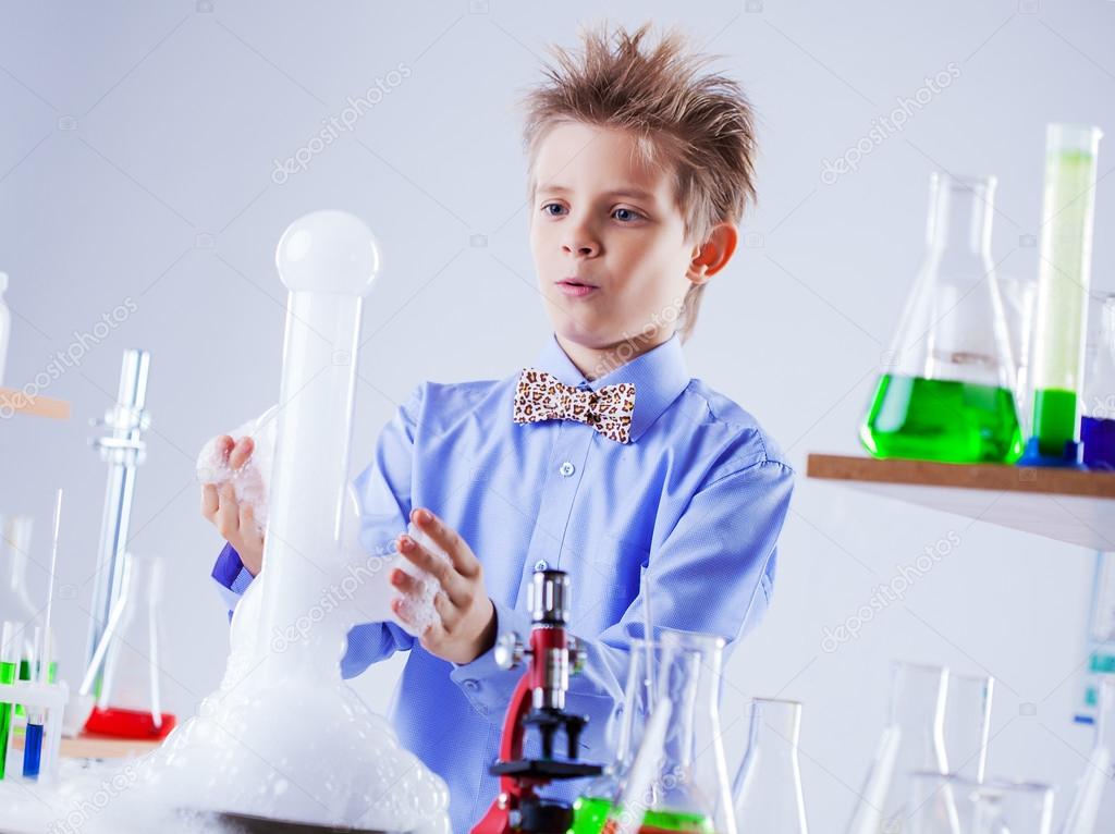 Nosy schoolboy watching reaction of experiment
