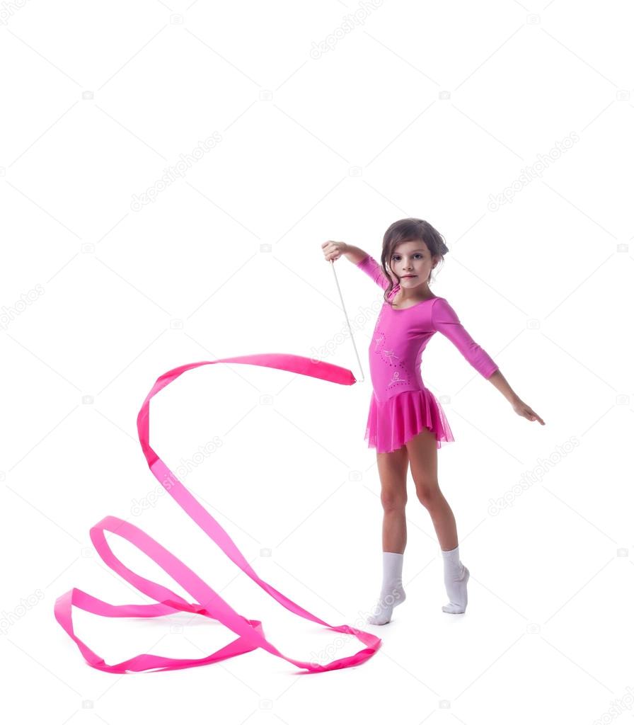 Adorable little gymnast dancing with ribbon